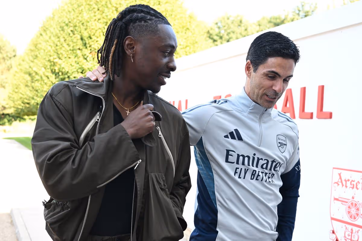 Eberechi Eze is greeted by Arsenal manager Mikel Arteta before signing for Arsenal at Sobha Realty Training Center on August 23, 2025 in London Colney, England. 